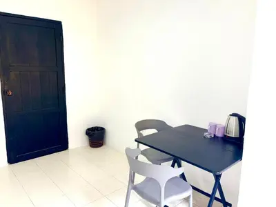 a black table and chairs in a room with a door at Patong Canal Villa 109 in Patong Beach