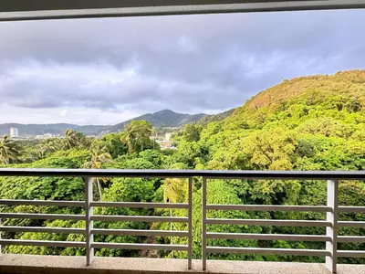 a view of a forest from a balcony at Veloche Peaceful Condo In Karon Beach in Karon Beach
