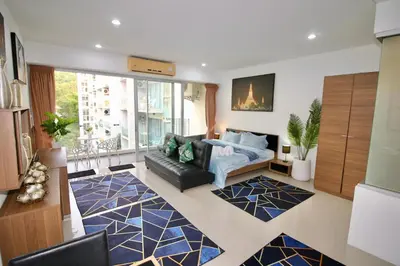 a living room with a couch and a large window at Chic Condominium A 518 in Karon Beach