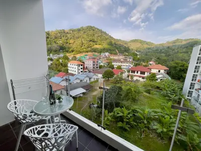 a balcony with a table and chairs and a view at Chic Condominium A 518 in Karon Beach