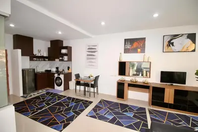 a living room with a desk and a table at Chic Condominium A 518 in Karon Beach