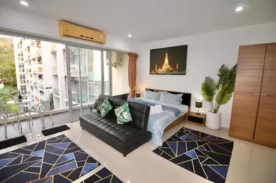 a bedroom with a bed and a couch in a room at Chic Condominium A 518 in Karon Beach
