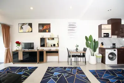 a living room with a desk and a table at Chic condominium A4 floor in Karon Beach