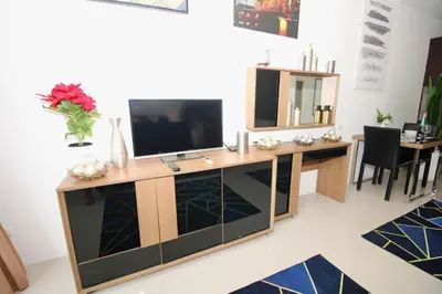 a living room with a television on a desk at Chic condominium A4 floor in Karon Beach