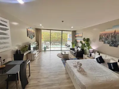 a large room with a bed and a living room at Veloche 2 Floor in Karon Beach