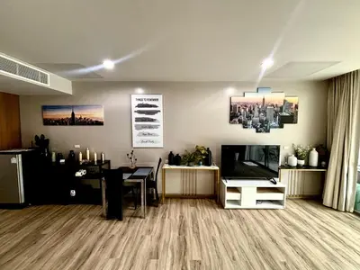 a living room with a television and a dining room at Veloche 2 Floor in Karon Beach