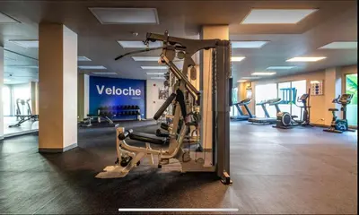 a gym with several tread machines in a room at Veloche 2 Floor in Karon Beach