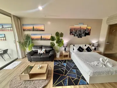 a living room with a bed and a couch at Veloche 2 Floor in Karon Beach