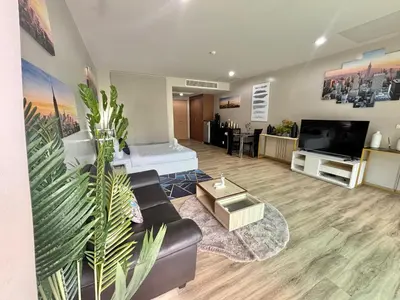 a living room with a couch and a flat screen tv at Veloche 2 Floor in Karon Beach