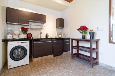 a kitchen with a washing machine and a dishwasher at Rawai Beach Villa in Rawai Beach