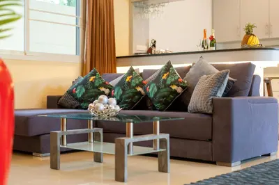 a living room with a couch and a table at Rawai Beach Villa in Rawai Beach