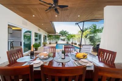 a dining room with a table with bananas on it at Rawai Beach Villa in Rawai Beach