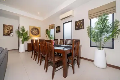 a dining room with a table and chairs at Naiharn Beach 4 Bedroom Villa in Nai Harn Beach