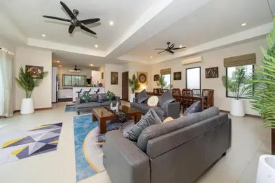a living room with couches and a ceiling fan at Naiharn Beach 4 Bedroom Villa in Nai Harn Beach