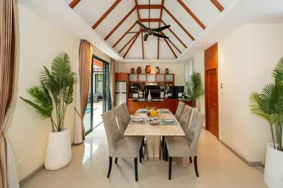 a dining room with a table and chairs at Rawayana 3 Bedroom Villa in Rawai Beach