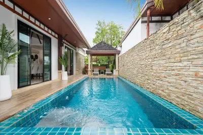 an infinity pool in a house with a brick wall at Rawayana 3 Bedroom Villa in Rawai Beach