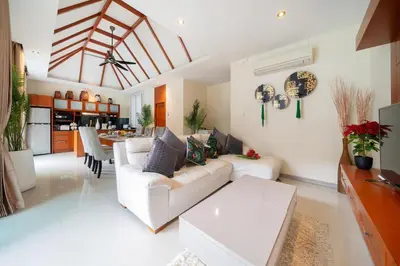 a living room with a white couch and a table at Rawayana 3 Bedroom Villa in Rawai Beach
