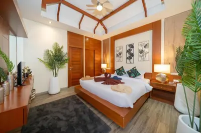 a bedroom with a large white bed and plants at Rawayana 3 Bedroom Villa in Rawai Beach
