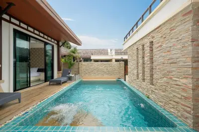 a swimming pool in the backyard of a house at Rawai Park Big Garden Villa 3D10 in Rawai Beach