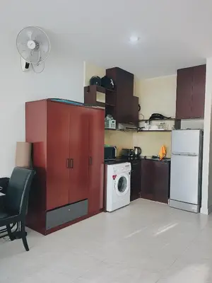 a kitchen with a washing machine and a washer at Chic 10 minutes to reach the karon beach, with free swimming pool and gym, WIFI in Karon Beach