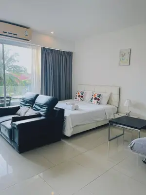 a bedroom with a bed and a couch and a window at Chic 10 minutes to reach the karon beach, with free swimming pool and gym, WIFI in Karon Beach