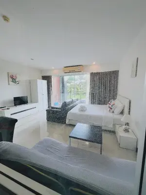 a large room with a bed and a living room at Chic 10 minutes to reach the karon beach, with free swimming pool and gym, WIFI in Karon Beach