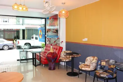 a restaurant with chairs and tables in a room at Tulip Inn in Patong Beach