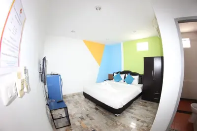 a bedroom with a bed and a sink in a room at Tulip Inn in Patong Beach