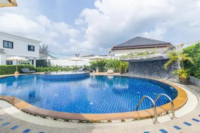 a swimming pool in the middle of a house at Bee Villa Wellness Resort Phuket in Laguna Phuket