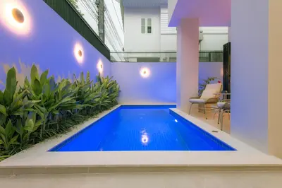 a swimming pool in the middle of a house at Palazzo 126 Luxury 5BR Pool Villa in Patong in Patong Beach