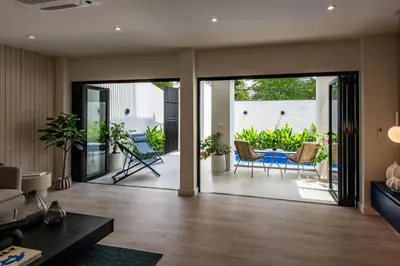 an open living room with sliding glass doors at Palazzo 126 Luxury 5BR Pool Villa in Patong in Patong Beach