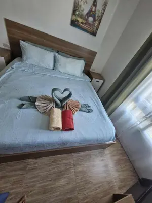 a bed with two hearts pinned to it at Calypso Condo Naiharn in Phuket Town