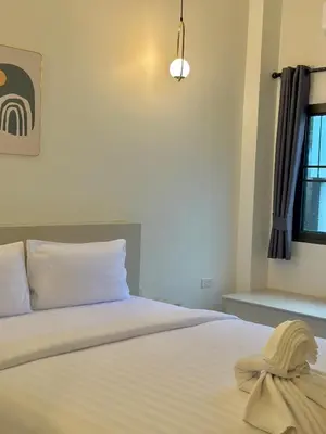 a bedroom with a bed with a towel on it at Kata Platinum in Kata Beach