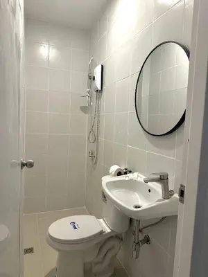 a bathroom with a toilet and a sink and a mirror at Kata Platinum in Kata Beach