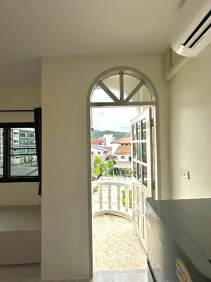 an open hallway with an arch window in a building at Kata Platinum in Kata Beach