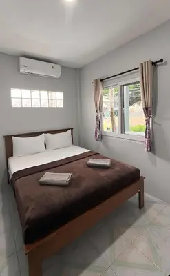 a bedroom with a large bed with two towels on it at Gypsy Village Resort in Phi Phi Don