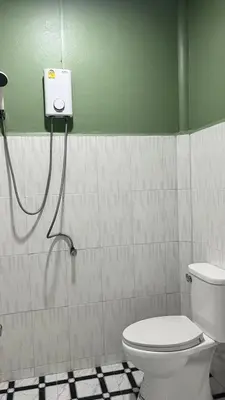a bathroom with a toilet and a shower at Gypsy Village Resort in Phi Phi Don