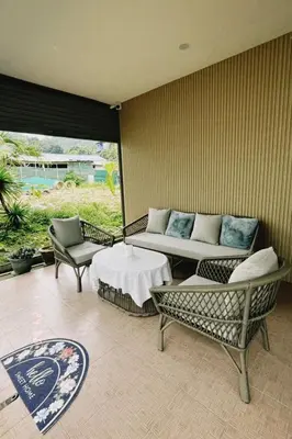 a living room with a couch and a table and chairs at Gypsy Village Resort in Phi Phi Don