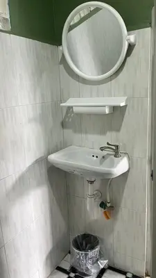a bathroom with a white sink and a mirror at Gypsy Village Resort in Phi Phi Don