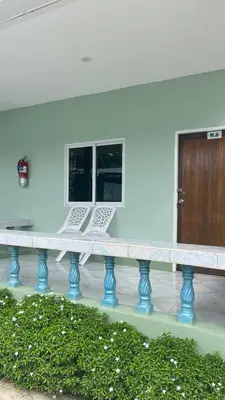 a table with a laptop sitting on top of it at Gypsy Village Resort in Phi Phi Don