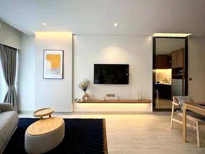 a living room with a couch and a tv at New apartments in a premium Laguna complex by the lake in Bang Tao Beach