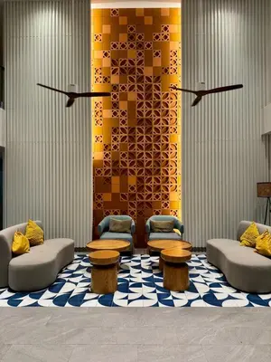a lobby with couches and tables on a rug at New apartments in a premium Laguna complex by the lake in Bang Tao Beach