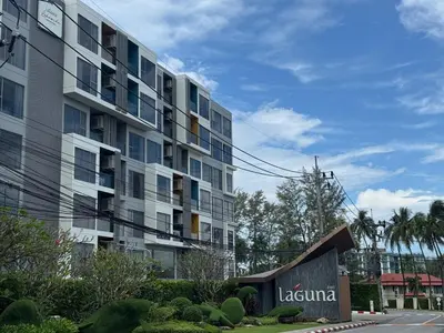 a large apartment building with a sign in front of it at New apartments in a premium Laguna complex by the lake in Bang Tao Beach