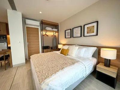 a bedroom with a large white bed and a table at New apartments in a premium Laguna complex by the lake in Bang Tao Beach