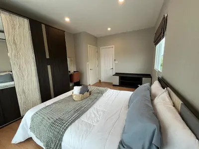 a bedroom with a large white bed and a piano at Modern 3 BR Villa Pool&Gym only 15min to Bang Tao Beach in Ban Phru Champa