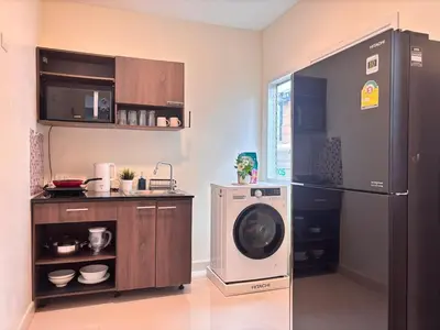 a kitchen with a refrigerator and a washer at Modern 3 BR Villa Pool&Gym only 15min to Bang Tao Beach in Ban Phru Champa