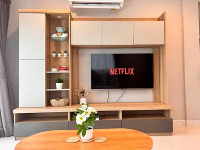 a living room with a tv and a table at Modern 3 BR Villa Pool&Gym only 15min to Bang Tao Beach in Ban Phru Champa