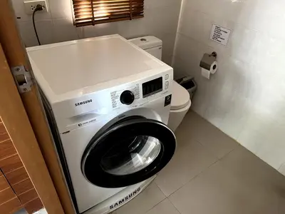 a washing machine in a bathroom with a toilet at Casa Sakoo pool Villa Naithon in Nai Thon Beach