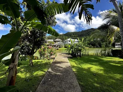 a path through a garden with a house in the background at Casa Sakoo pool Villa Naithon in Nai Thon Beach