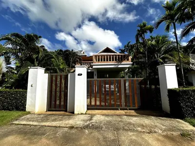 a gate in front of a house with palm trees at Casa Sakoo pool Villa Naithon in Nai Thon Beach